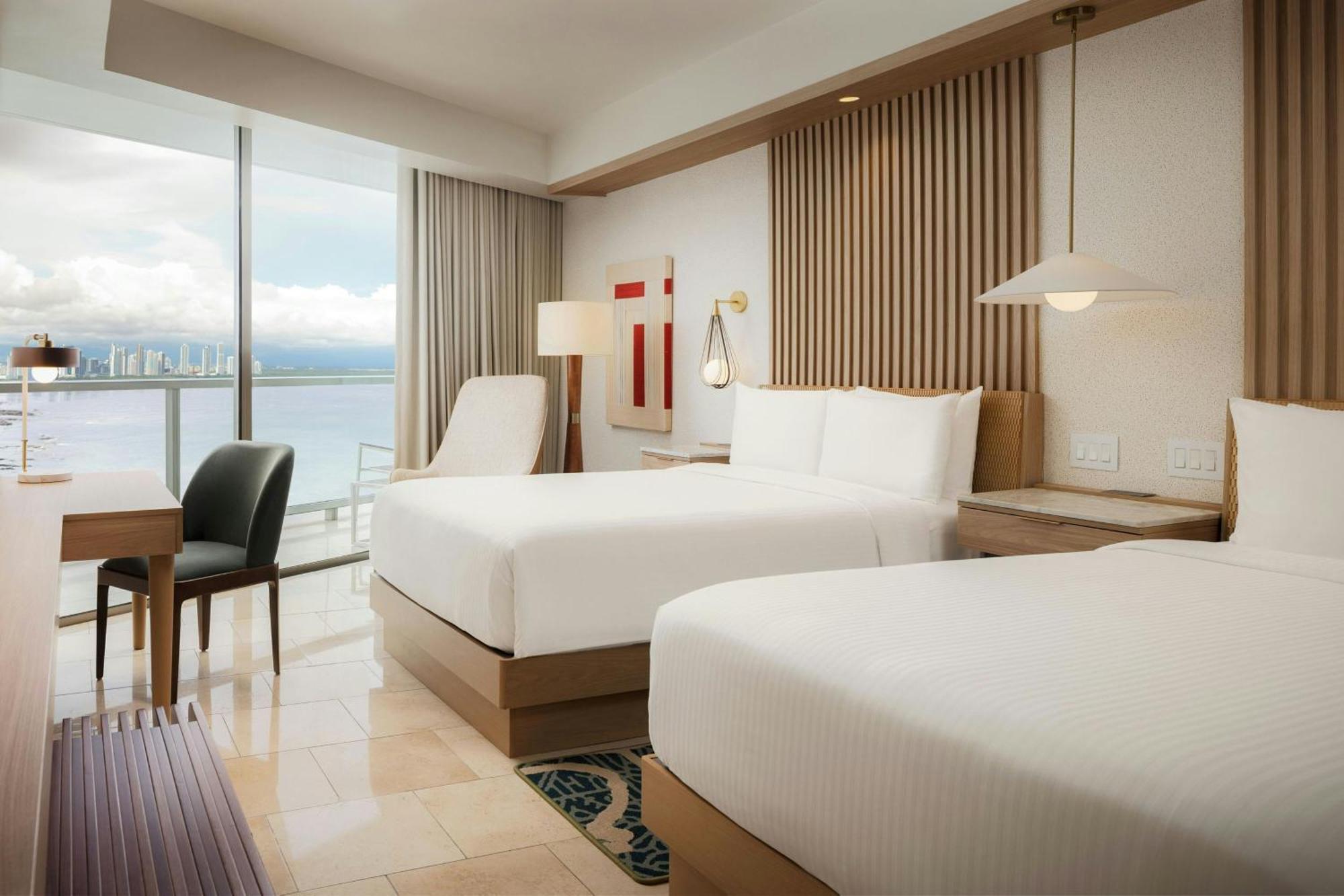 Guest room 2 double beds balcony partial ocean view